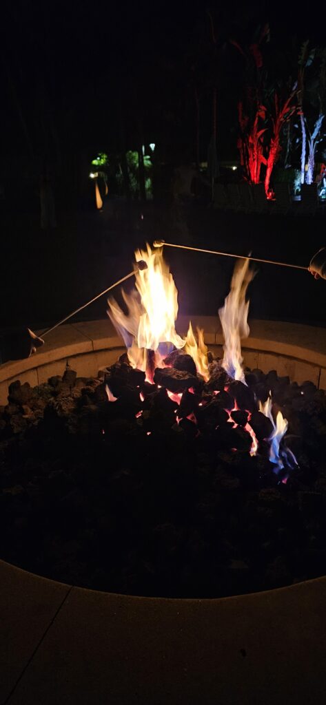 Family making s’mores by the fire pit at Paradise Point Resort in San Diego at night